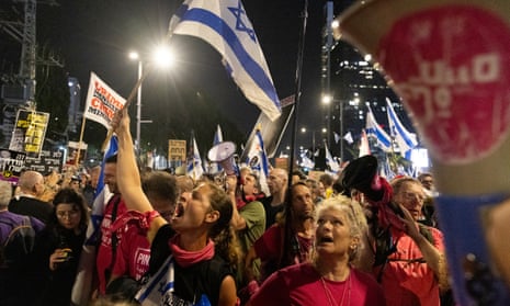 Protesters hold flags and signs during a demonstration against Israeli prime minister Benjamin Netanyahu. Protesters called for a deal with Hamas to release hostages.