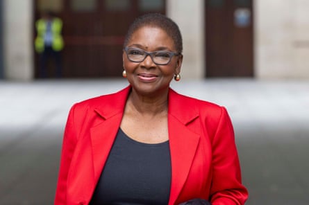 Valerie Amos wearing glasses and a bright red jacket.