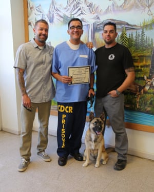 ‘I learned to be honest’: (from left) trainer Robert Villaneda and Pawsitive Change founder Zach Skow with Isaac and his newly acquired trainer’s certificate