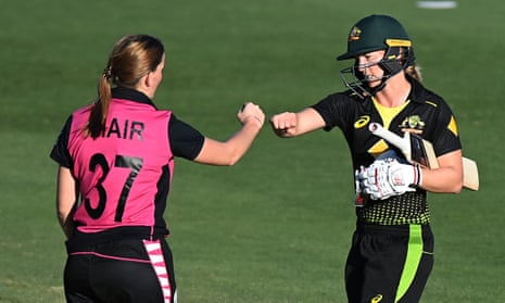 Meg Lanning of Australia bumps fists with Rosemary Mair of New Zealand