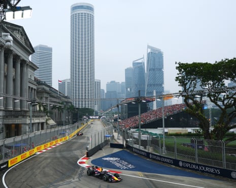 Red Bull's Max Verstappen leads the field round the streets of Singapore.