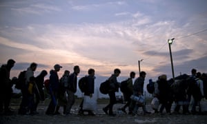 Migrants and refugees queue at a camp to be registered after crossing the Macedonian-Greek border near Gevgelija