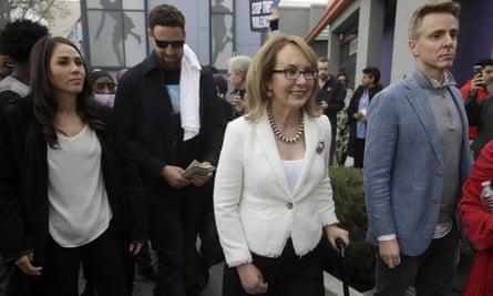 Gabby Giffords, center, walks with Golden State Warriors’ Klay Thompson, second from left, during a peace march.