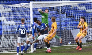 Oldham keeper Laurie punches Luke Hannant’s corner into the net for Cambridge United’s fourth goal.