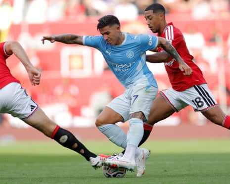 Enzo Fernandez of Manchester City dribbles in between Harry Maguire and Youri Tielemans