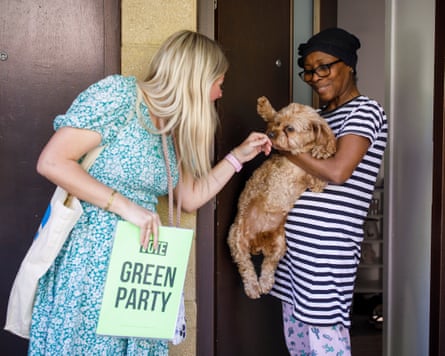 Russell and Boampong. Cynthia is holding her dog and Lorna is putting her hand out towards the dog