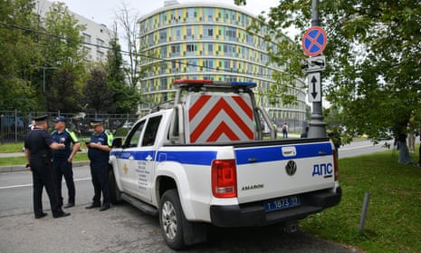 Security forces – three men and liveried pickup truck – are seen outside Moscow’s City Clinical hospital No 67 near the site of an attempted attack by a Ukrainian drone on 11 August 2023.