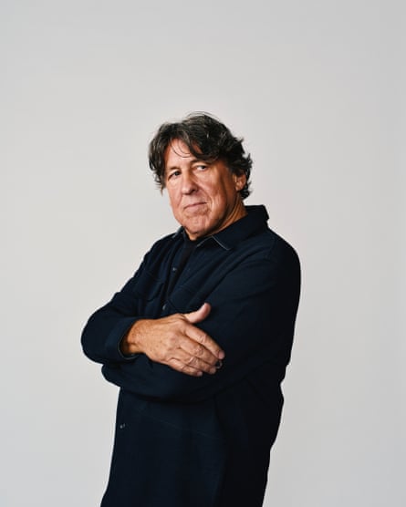 Portrait of Cameron Crowe in a dark top with his hands wrapped around his chest