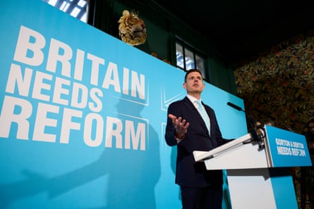 Matt Goodwin standing behind a podium