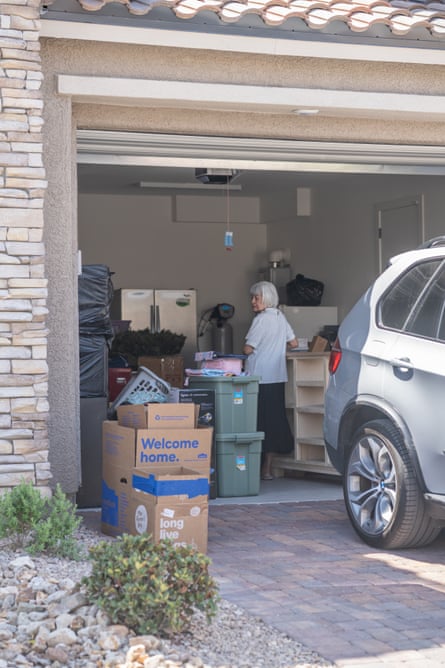 woman in an open garage surrounded by boxes