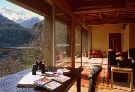 A room with large windows looking out to mountains and valley.