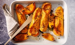 Butternut squash cooked in olive oil. Dish of baked Butternut squashes ready to eat. Dish of freshly roasted butternut squashes cooked until they are soft, with thyme, bay leaves and olive oil.