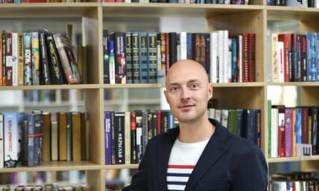Vladimir Kosarevsky in front of a row of bookshelves