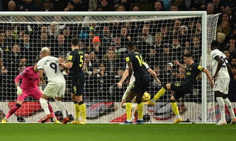 Newcastle United's Miguel Almiron clears off the line from Tottenham Hotspur's Cristian Romero.