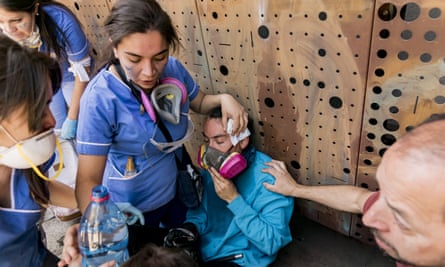 Nursing students take care of an injured person during protests.