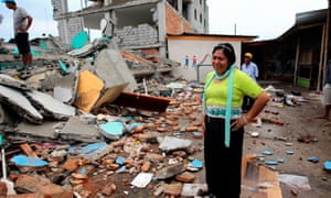 A woman cries as she views the crumbled remains of her home in the town of Pedernales.