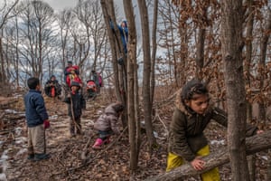 Children play while families wait to make the attempt to cross into Croatia