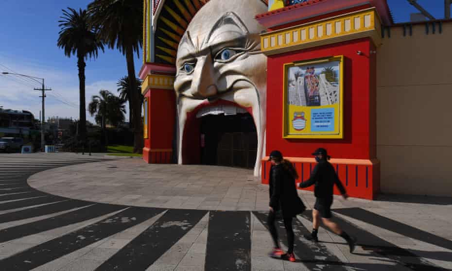 People walk past the empty Luna Park in Melbourne on Tuesday. The age group in Victoria with the highest amount of active Covid-19 cases is 20-29 years, with 1,823 infections.