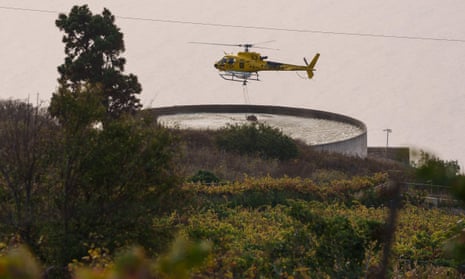 A firefighting helicopter refills water at a reservoir on Tenerife in August.