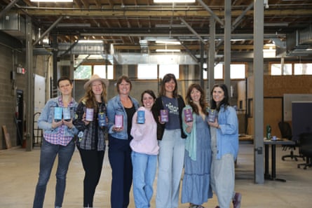 seven women posing with Asheville Tea Co bags
