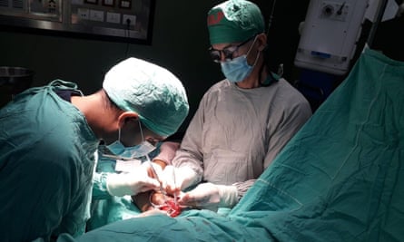 Surgeons operating on a patient