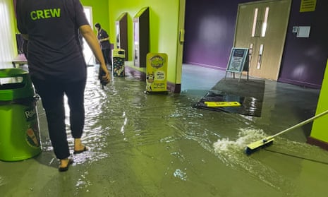 Staff clean up after flooding at the Milky Way adventure park in Devon as thunderstorms swept across south-west and eastern England.