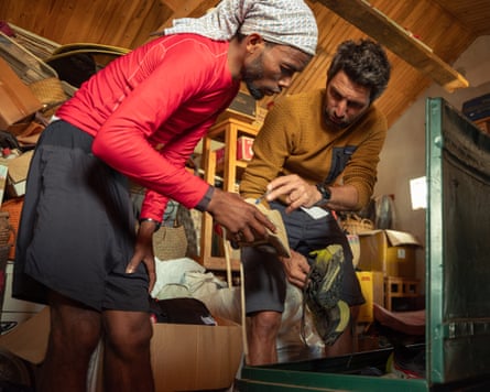 Two men looking at used running shoes.