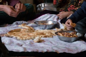 A family share a piece of naan bread