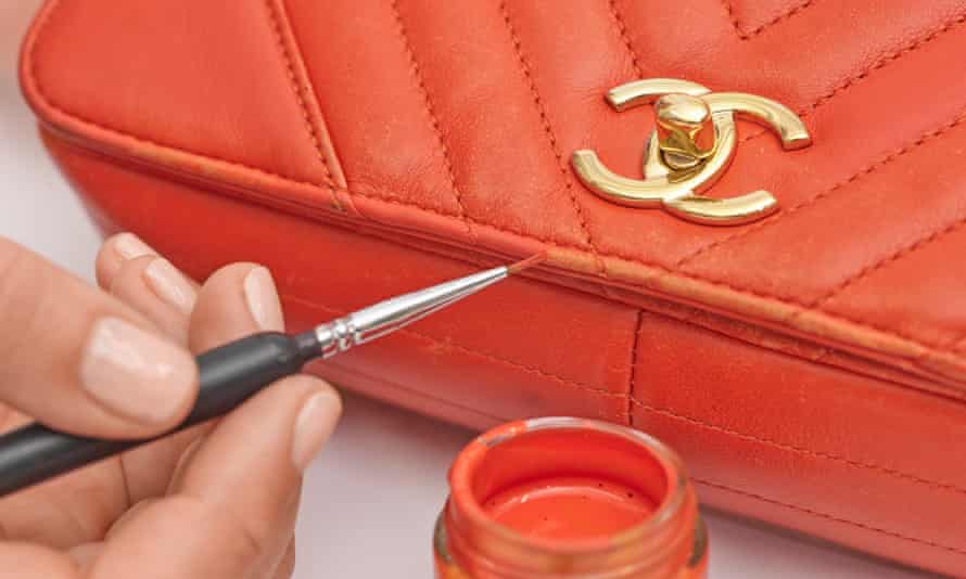 Colour being painted on to a red Chanel bag