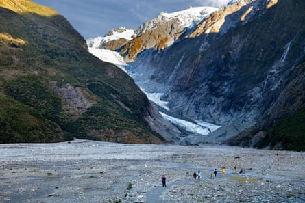 People dwarfed by the Kā Roimata o Hine Hukatere glacier