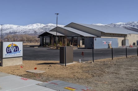 low building with pointed roofs near mountains