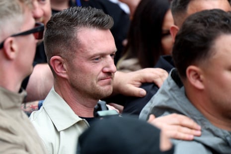 Tommy Robinson standing among protesters.