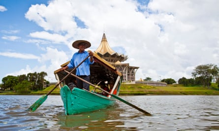 A tambang (sampan water taxi) boatman on the Sarawak River, Kuching, Sarawak, Borneo, Malaysia
