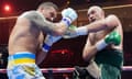 Usyk and Fury trade blows during their heavyweight title fight.