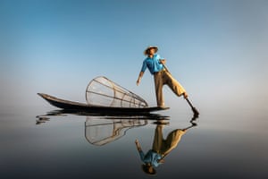 An Intha fisherman paddles his boat on Inle lake, Shan state, Myanmar