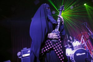 Gisele Marie, a Muslim heavy metal musician, plays her guitar during a concert in Sao Paulo, Brazil.