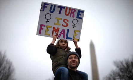A man and his daughter participate in the Women’s March on Washington, the day after Trump’s inauguration.