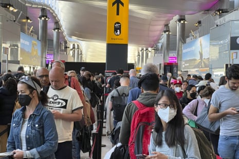 Travellers queue at security at Heathrow Airport in London last month