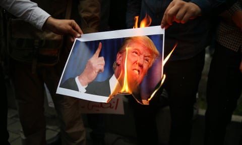 Iranians burn a photo of Donald Trump in Tehran.