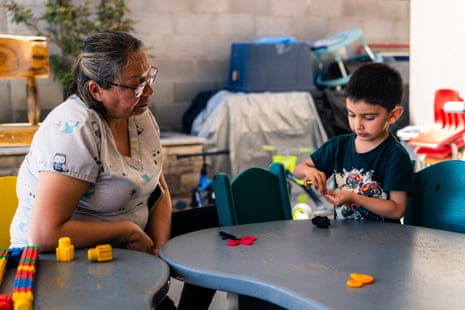 a women helping a boy