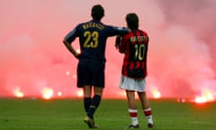 Marco Materazzi and Rui Costa watch on as fans throw flares on to the pitch during their 2005 Champions League meeting
