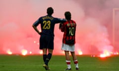 Inter Milan's Materazzi and Rui Costa of AC Milan wait on the pitch during their Champions League ...<br>Inter Milan's Materazzi and Rui Costa of AC Milan wait on the pitch during their Champions League soccer match in Milan. Inter Milan's Marco Materazzi (L) and AC Milan's Manuel Rui Costa waits on the pitch as supporters throw flares onto the pitch during their Champions League quarter-final second leg soccer match at the San Siro Stadium in Milan April 12, 2005. Pictures of the Month April 2005 REUTERS/Stefano Rellandini PP05070289