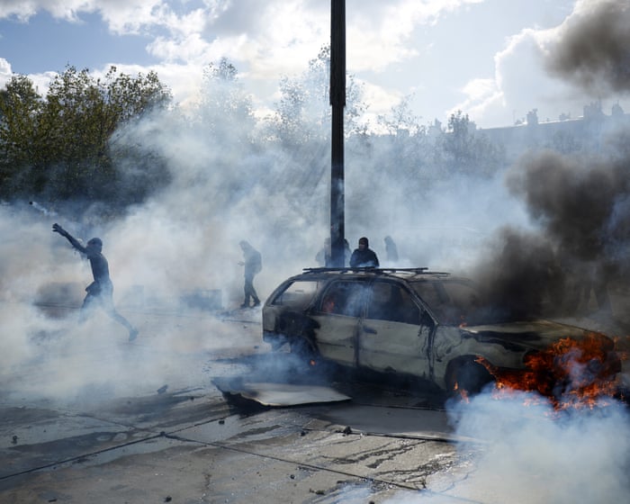 Police clash with protesters as tens of thousands take to streets across France