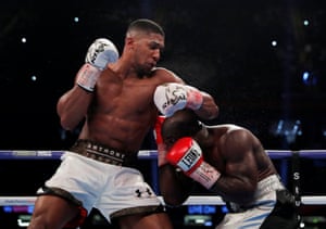 Anthony Joshua tussles with Carlos Takam.