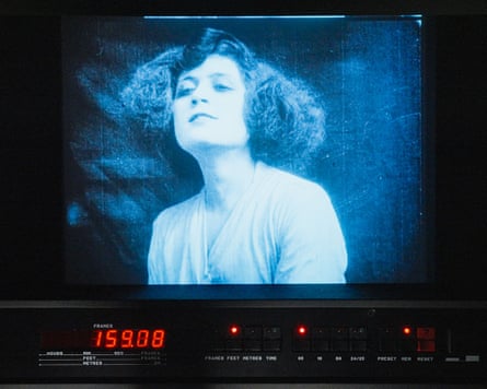 A black-and-white image of a woman in a film, with the camera’s digital display visible