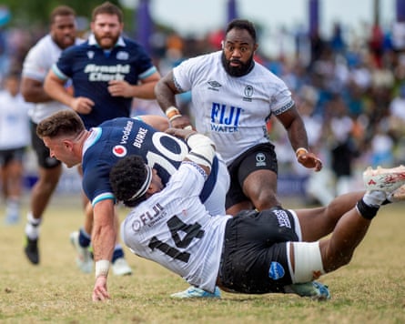 Fiji's Kalaveti Ravouvou takles Scotland's Fergus Burke