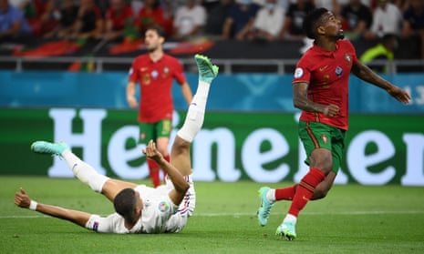 Kylian Mbappe of France is fouled by Nelson Semedo of Portugal leading to a penalty being awarded.