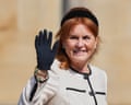 Sarah Ferguson, smiling with red hair and black headband, waves in a black glove