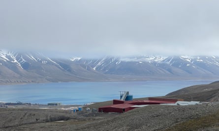 The Frozen Ark project by the side of a lake with snow-topped mountains in the disatance