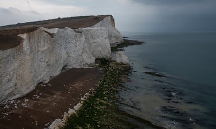 Agua marrón turbia en el mar al pie de los acantilados en Seaford, Inglaterra